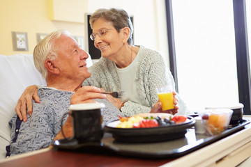 Wall Mural - Senior Couple In Hospital Room As Male Patient Has Lunch