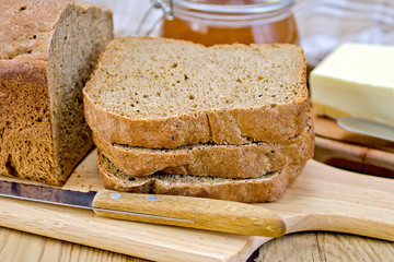 Poster - Rye homemade bread stacked with honey and knife