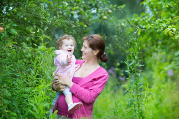 Wall Mural - Beautiful pregnant mother with her one year old baby daughter