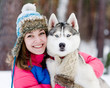 closeup teen girl embracing cute dog in winter park