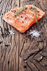 Wall Mural - Salmon filet on a wooden carving board.