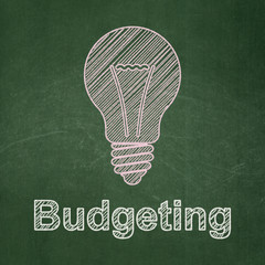 Business concept: Light Bulb and Budgeting on chalkboard