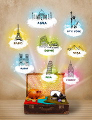 Wall Mural - Tourist suitcase with famous landmarks around the world