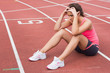 © WavebreakMediaMicro - Young sporty woman sitting on the running track