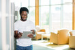 © Tyler Olson - Smiling Student Using Digital Tablet At Library
