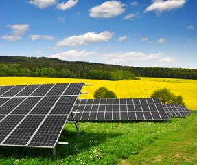 Wall Mural - Solar energy panels against blue sky with clouds