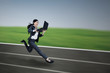 © Creativa Images - Attractive businesswoman running with laptop