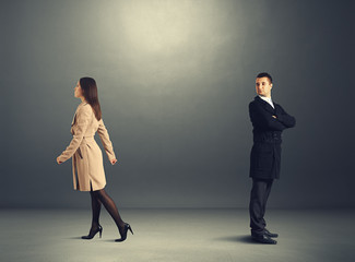 Wall Mural - woman going out and man looking at her