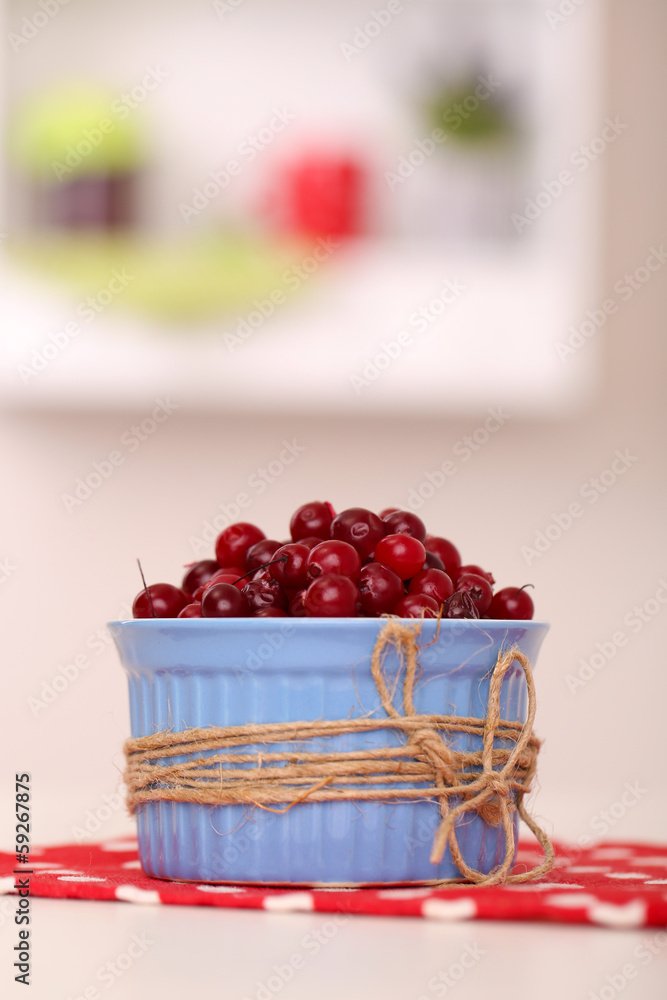 Ripe red cranberries in bowl on table