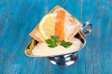 Sticker - Salmon sandwich with sauce on wooden table close-up