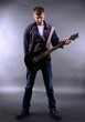 © Africa Studio - Young musician playing  guitar on gray background