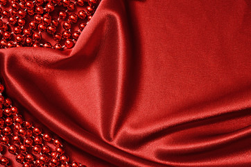Red satin drapery and beads