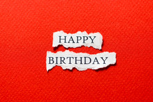 Red Happy Birthday On Scrap Of Paper