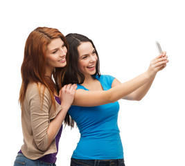 Wall Mural - two smiling teenagers with smartphone