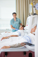 Wall Mural - Nurse Standing By Patient Undergoing Renal Dialysis