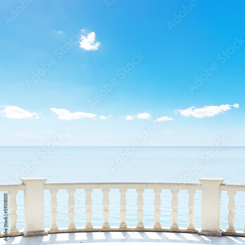 Naklejka ścienna white balcony on terrace near sea and blue sky