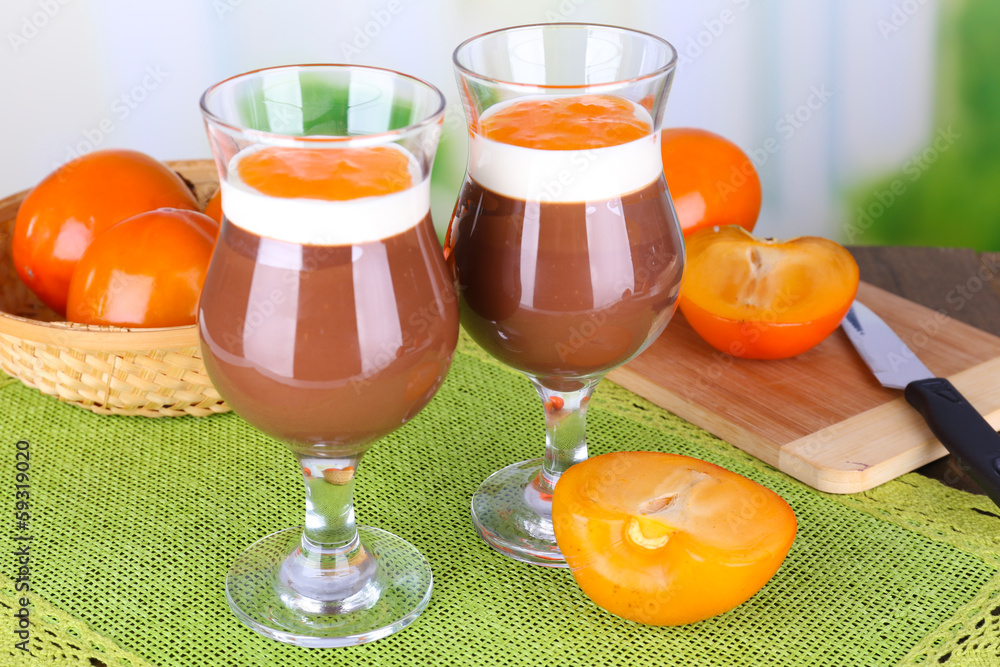 Dessert of chocolate and persimmon on table on light background