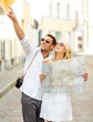 © Syda Productions - smiling couple in sunglasses with map in the city