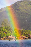 Fototapeta Tęcza - Big Rainbow over tropical island and luxurious hotel at