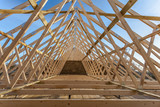 Fototapeta  - Wood house truss against blue sky 