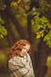© GTeam - Portrait of young beautiful redhair woman standing in green park