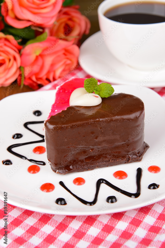 Sweet cake with chocolate on plate on table close-up