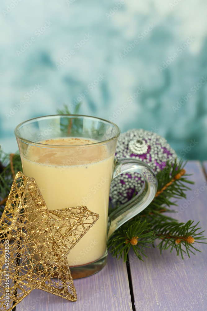 Cup of eggnog with fir branches and Christmas decorations