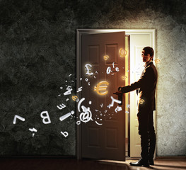 Wall Mural - Young businessman opening door