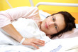 © ArtushFoto - smiling middle-aged woman lying in hospital