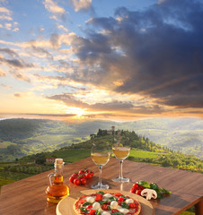 Wall Mural - Italian pizza and glasses of white wine in Chianti, Italy