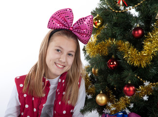 girl decorates the Christmas tree