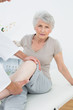 © lightwavemedia - Portrait of a senior woman getting her leg examined