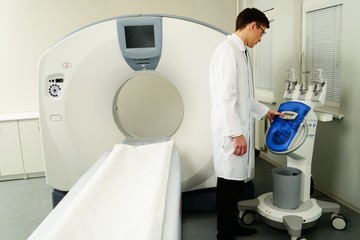 Wall Mural - Doctor standing near computed tomography scanner in a hospital