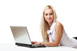 © lenets_tan - young business woman lying and working on a laptop.