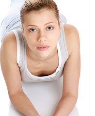 Wall Mural - Portrait of a smiling young woman lying on the floor