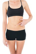 © lightwavemedia - Close-up mid section of a fit woman with hand on stomach