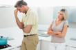 © lightwavemedia - Angry couple after a fight in kitchen
