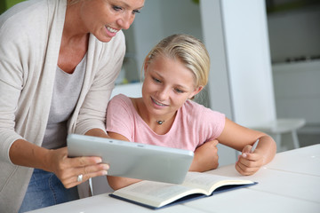 Wall Mural - Mother helping girl with homework