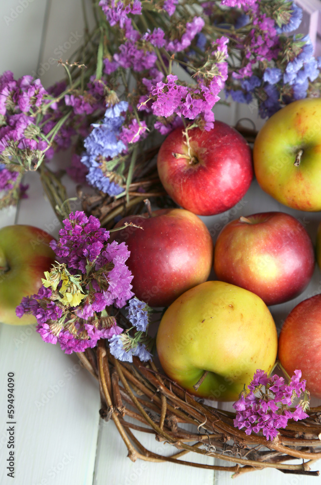 Juicy apples in box on white wooden table