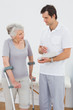 © lightwavemedia - Therapist discussing reports with a disabled senior patient