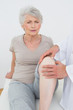 © lightwavemedia - Displeased senior woman getting her knee examined