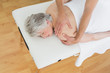 © lightwavemedia - Physiotherapist massaging a senior woman's back