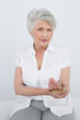 © lightwavemedia - Portrait of a senior woman with hand in wrist brace