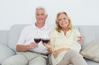 © lightwavemedia - Senior couple toasting wine glasses at home