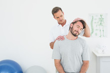 Male Chiropractor Doing Neck Adjustment