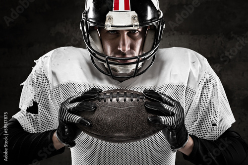 Foto-Plissee - Portrait of american football player holding a ball and looking (von guerrieroale)