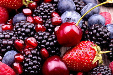 tasty summer fruits on a wooden table