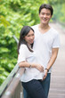 © wong yu liang - Happy young pregnant asian couple in the nature