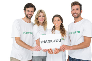 Canvas Print - Portrait of happy volunteers holding 'thank you' board