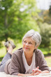 © WavebreakmediaMicro - Thoughtful senior woman lying at park